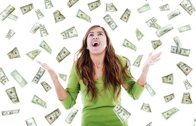 Person in green dress looking toward the sky as money falls down.