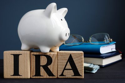 IRA letters with piggy bank book and glasses